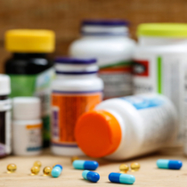 Medicine bottles and tablets on wooden deskMedicine bottles and tablets on wooden desk