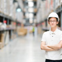 Asian engineer or technician, warehouse blur background