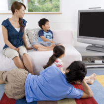 Family watching TV in living room