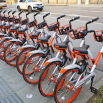 Tianjin, China - March 11, 2017: Mobike bicycles parking in a row in Tianjin, China. Mobike is a fully station-less bicycle-sharing system, created by Beijing Mobike Technology Co., Ltd.