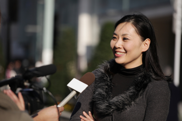 Japanese Woman being interviewed for TV on the street in Tokyo